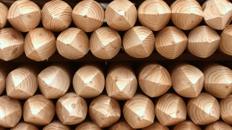 Wooden-sharpened-logs-are-in-rows-in-warehouse.-Processed-logs-in-warehouse