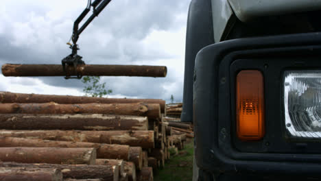 Modern-logger-working-in-sawmill.-Powerful-tree-logger-lifting-logs