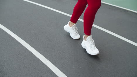 Close-up-of-woman-runner-feet-running-at-sport-stadium.-Female-feet-running