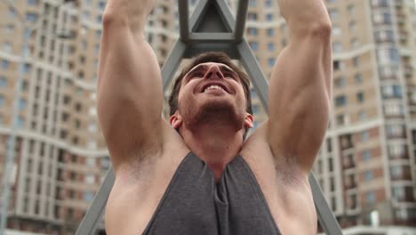 Close-up-of-athlete-man-working-out-outdoor.-Fitness-guy-doing-pull-ups