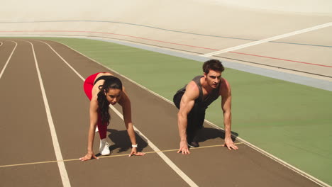 Fitness-couple-training-together-at-stadium.-Sport-couple-running-together