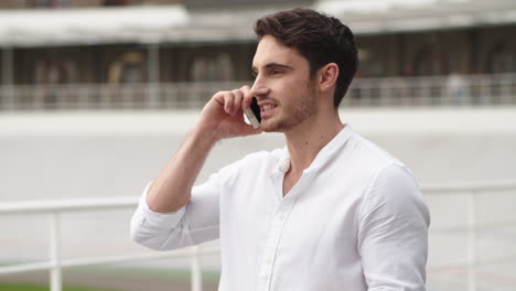 Serious-businessman-talking-mobile-phone-outdoors.-Young-business-man