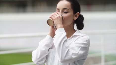 Business-woman-talking-phone-outdoor.-Girl-drinking-coffee-on-break-outdoor