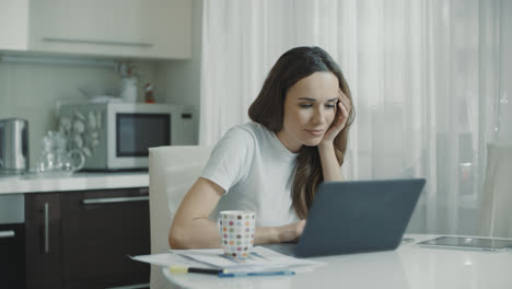 Tired-woman-working-laptop-computer-at-home-workplace.-Frustrated-person