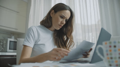 Thoughtful-woman-working-with-documents-at-home.-Worried-business-woman