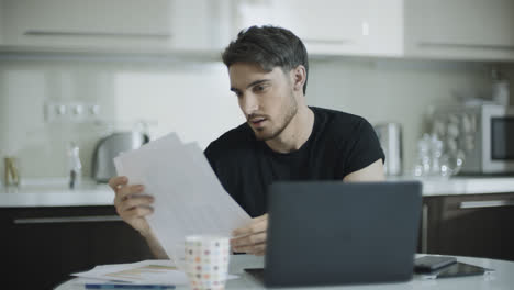 Businessman-looking-paper-at-home-workplace.-Young-business-man-work-with-papers