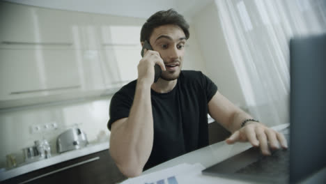 Happy-man-talking-mobile-phone-at-home.-Portrait-of-smiling-business-man