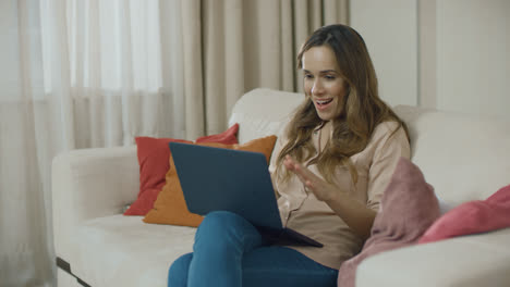 Happy-woman-looking-laptop-computer-at-home.-Excited-business-woman