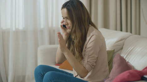 Angry-woman-talking-phone-at-home.-Portrait-of-upset-person-call-mobile-phone