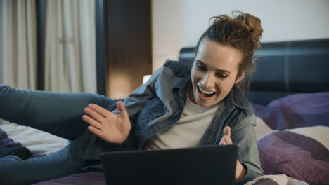 Happy-woman-laughing-with-laptop-at-home.-Excited-person-clapping-hand