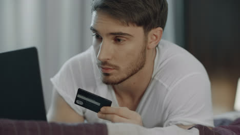 Man-using-credit-card-for-online-payment-on-computer.-Technology-purchase