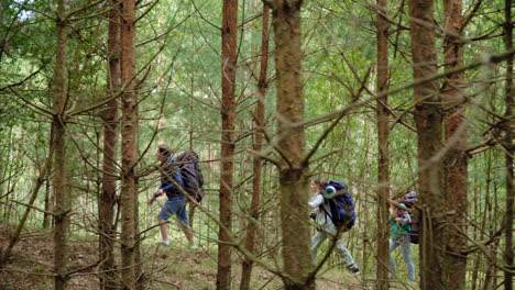 Tourists-walk-through-forest.-Young-travelers-make-their-way-through-dense-forest