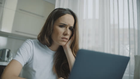 Tired-woman-looking-at-laptop-computer.-Portrait-of-sad-woman-using-laptop