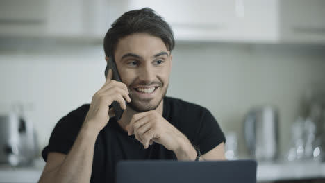 Happy-business-man-talking-phone-at-home.-Happy-businessman-using-mobile-phone