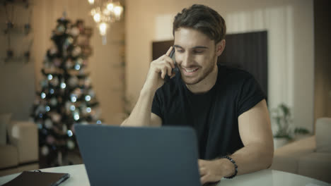 Happy-man-talking-mobile-phone-at-new-year.-Business-man-working-at-christmas