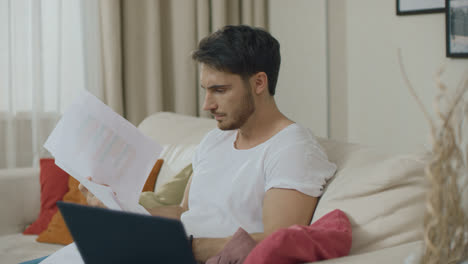 Worried-man-working-with-financial-documents-at-home.-Frustrated-businessman