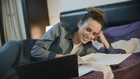 Happy-woman-working-with-documents-at-home.-Smiling-woman-doing-paperwork
