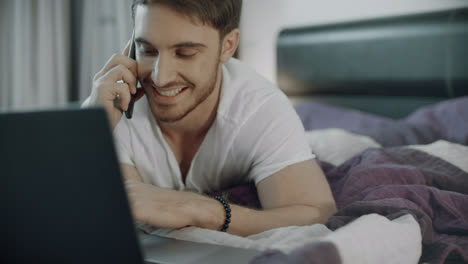 Happy-man-talking-phone-on-couch-at-home.-Telecommunication-lifestyle