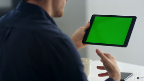 Closeup-business-man-making-video-call-on-green-screen-tablet.