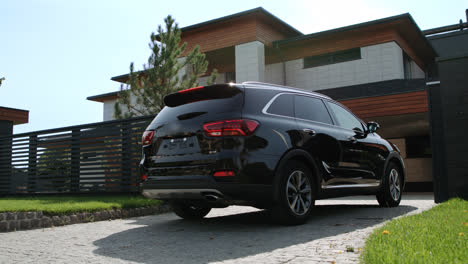 Modern-auto-driving-to-luxury-house.-Closeup-black-jeep-entering-luxury-garage.
