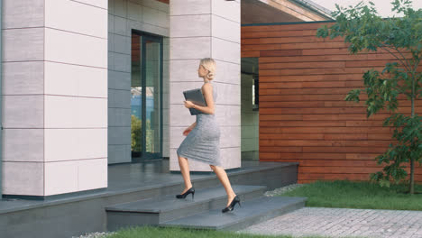 Beautiful-woman-entering-business-office-with-laptop.-Female-boss-arriving-work