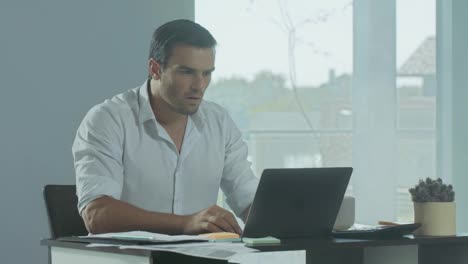 Business-man-getting-bad-news.-Depressed-male-freelancer-working-on-laptop.