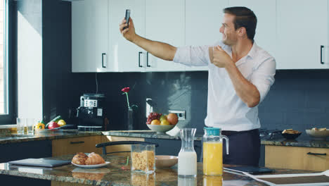 Business-man-making-selfie-photo-in-kitchen.-Happy-man-taking-photo-in-house.