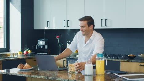 Business-man-talking-at-computer-in-kitchen.-Closeup-person-having-online-chat.