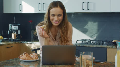 Business-woman-watching-video-kitchen.-Surprised-female-person-looking-at-laptop