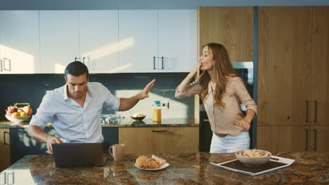 Couple-having-conflict-at-private-kitchen.-Frustrated-man-shouting-to-wife