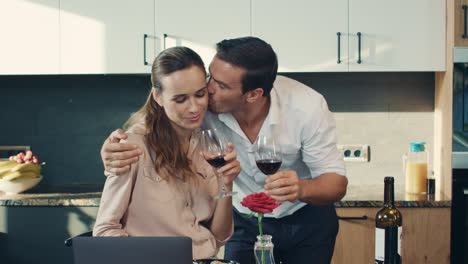 Happy-couple-drinking-red-wine-at-luxury-house.-Relaxed-family-clang-glasses.
