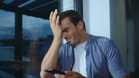 Business-man-getting-bad-news-on-phone.-Depressed-male-reading-shocked-message.