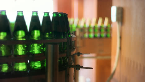 Beer-bottles-moving-on-conveyor-belt-at-factory.-Automated-manufacturing-line
