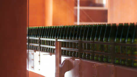 Beer-production-line-at-factory.-Close-up-of-conveyor-belt-with-alcohol-bottles