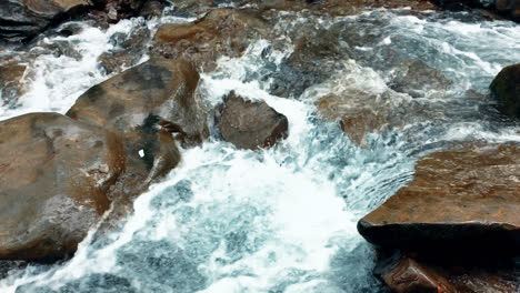 Clear-foaming-water-stream-between-stones.-Mountain-creek