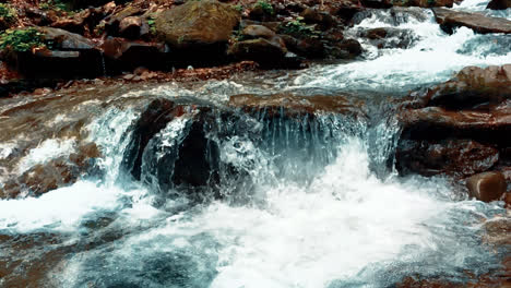 Crystal-cold-spring-water-flowing-through-stone.-Mountain-creek