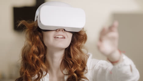 Young-woman-using-virtual-glasses.-Female-person-moving-arm-in-virtual-glasses.
