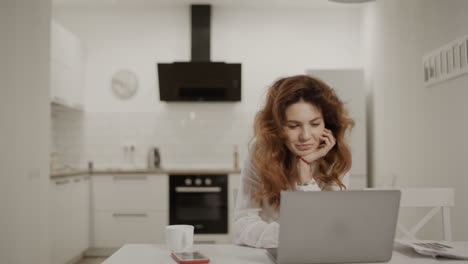 Happy-woman-making-morning-tea-at-home.-Smiling-lady-opening-laptop-computer