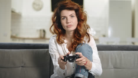 Playful-woman-trying-to-win-video-game-at-open-kitchen.