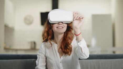 Beautiful-lady-playing-interactive-in-virtual-glasses-at-modern-kitchen.