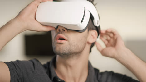 Young-man-putting-video-glasses.-Portrait-of-man-in-virtual-glasses-moving-arms.
