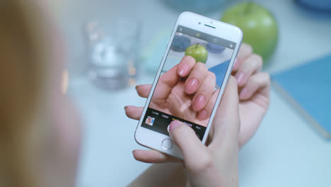 Woman-manicure-photo-on-mobile-phone.-Photo-hands-nail-polish