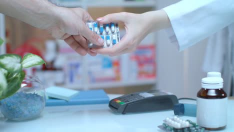 Man-buy-pills-with-credit-card.-Terminal-payment-at-drugstore