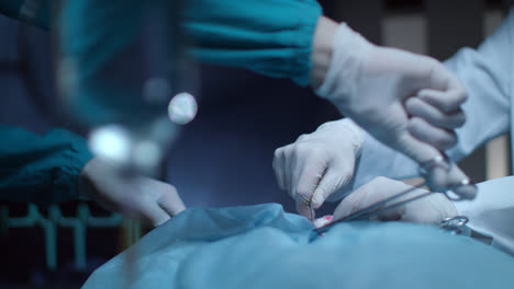 Surgery-operation-hands-in-operating-room.-Gloved-hand-hold-surgical-tools