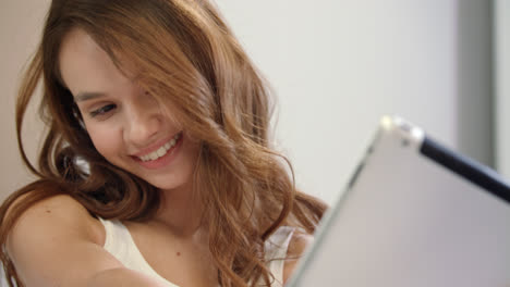 Happy-woman-taking-selfie-photo-on-tablet-computer.-Smiling-girl-posing-at-home