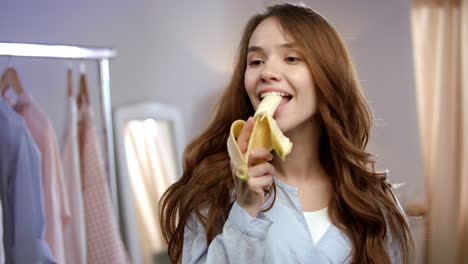 Happiness-woman-eating-banana.-Healthy-tropical-fruit-for-female-diet