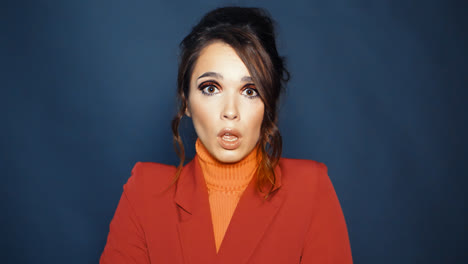 Woman-dressed-in-red-jacket-and-orange-sweater-expressing-variety-of-emotions