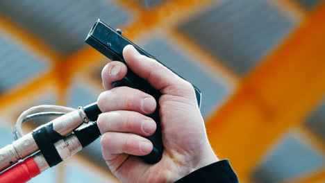 Close-up-of-male-hand-firing-starting-pistol-to-start-race.-Sportive-concept