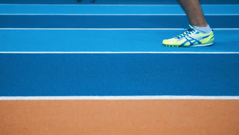 Athlete's-feet-wearing-sports-shoes-on-running-track.-Healthy-lifestyle-concept