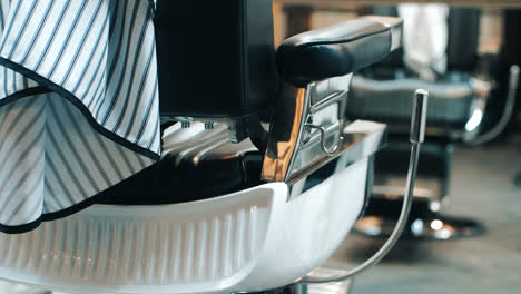 Barber-chair-rear-view.-Equipment-in-barbershop.-Armchair-in-beauty-saloon